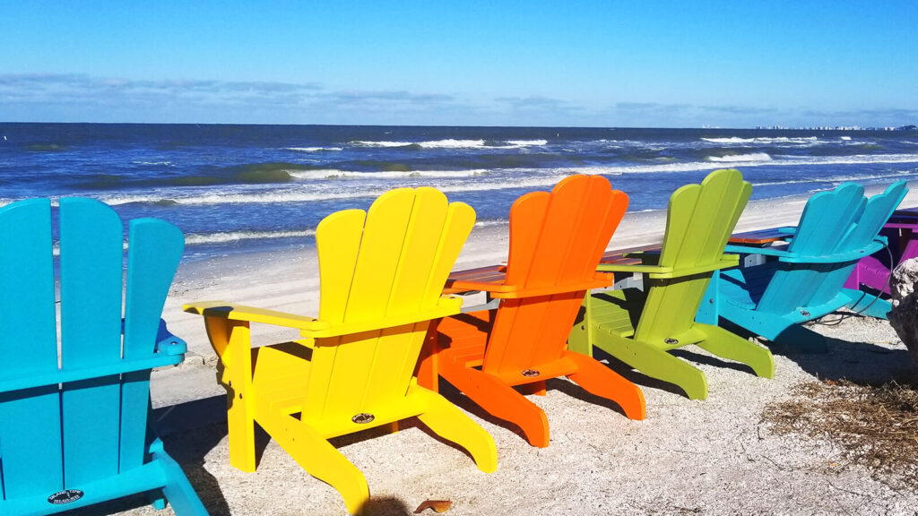 Colorful Adirondack Chairs on Beach